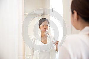 Asian young woman gargle on her mouth after tooth brushing