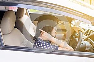 Asian young woman have a neck pain while driving a car,Massaging