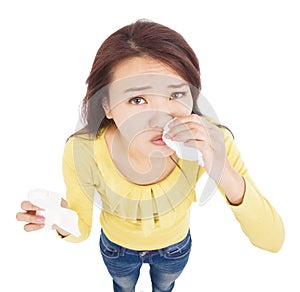 Asian young woman having runny nose with tissues