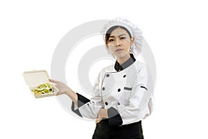 Asian young woman holding a food box paper with egg salad.