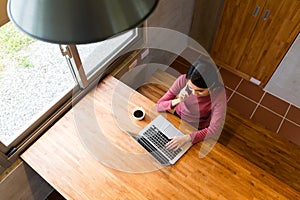 Asian Young Woman make a call on smart phone and working on note