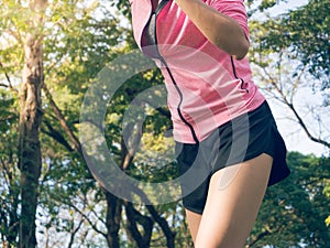 Asian young woman on mark to set ready for jogging exercise to buld up her body on glass in warm light morning.