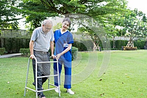 Asian young woman nurse at nursing home take care disabled senior man. Caregiver doctor serve physical therapy for older elderly