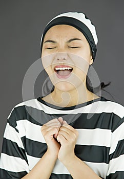 Asian young woman pleading in prisoners uniform