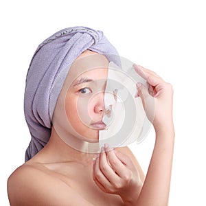 Asian young woman removing facial peel off mask isolated on white color background