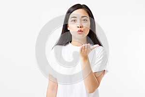 Asian young woman send air kiss. Valentine day and love concept. Girl in t shirt on isolated white blank template background.