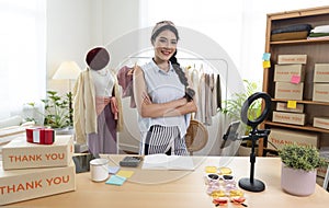 Asian young woman SME working with a box at home the workplace.start-up small business owner, small business entrepreneur SME or