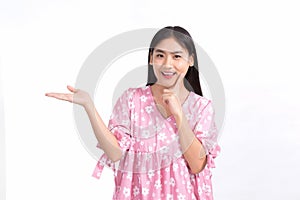 Asian young woman smiles and acts her hand to present something on the white background