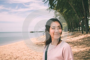 Asian young woman smiling with wind blowing her hair