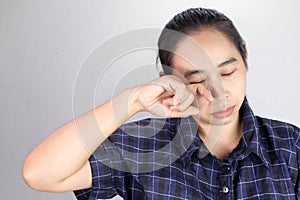 Asian young woman suffering from irritated eye, allergic or itching from dust. Optical health care concept