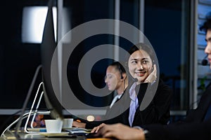 Asian young woman working overtime late at night in call center office