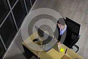 Asian young woman working overtime late at night in call center office. Top view