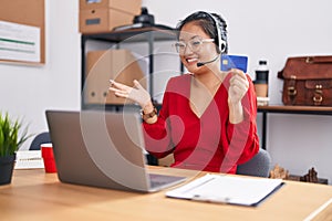 Asian young woman working using computer laptop and credit card celebrating achievement with happy smile and winner expression