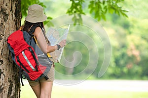 Asian young women holding map for check location adventure, tourism for destination leisure trips for education and relax in outdo