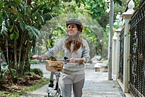 Asian young women walk on folding bikes