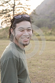 Asian younger man toothy smiling face happiness emotion standing