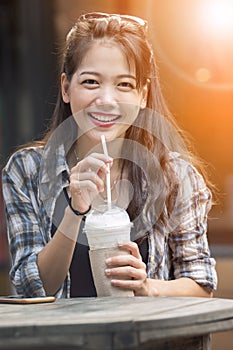 Asian younger woman toothy smiling face happiness drinking cool