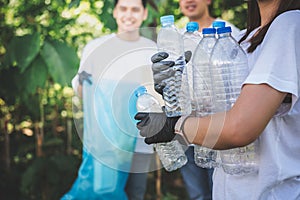 Asian youth volunteer group helping to collect garbage and plastic bottles in the park