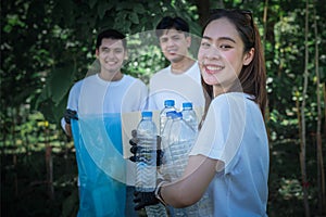 Asian youth volunteer group helping to collect garbage and plastic bottles in the park