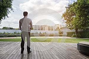 Asianman standing on wood floor