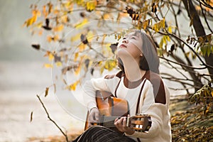 Asian girl playing the guitar.Country Western Musician