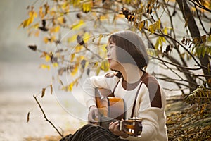 Asian girl playing the guitar.Country Western Musician