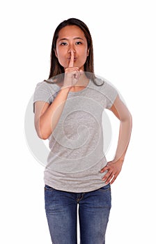 Asiatic charming young woman requesting silence photo