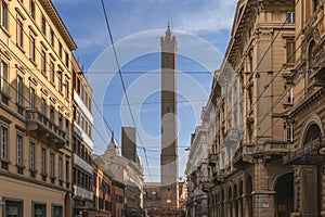 Asinelli Tower rises between traditional buildings on a calm Bologna day photo