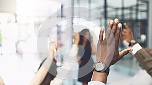 Ask as many questions as you need. Closeup shot of a group of businesspeople raising their hands during a presentation