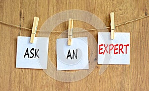 Ask an expert symbol. Concept words Ask an expert on white paper on a beautiful wooden table wooden background. Business and ask