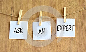 Ask an expert symbol. Concept words Ask an expert on white paper on a beautiful wooden table wooden background. Business and ask