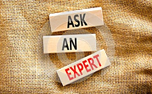 Ask an expert symbol. Concept words Ask an expert on wooden blocks on a beautiful canvas table canvas background. Business and ask