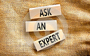 Ask an expert symbol. Concept words Ask an expert on wooden blocks on a beautiful canvas table canvas background. Business and ask