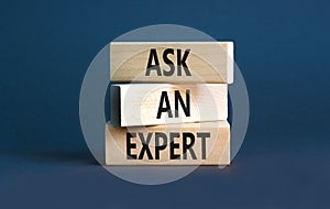Ask an expert symbol. Concept words Ask an expert on wooden blocks on a beautiful grey table grey background. Business and ask an
