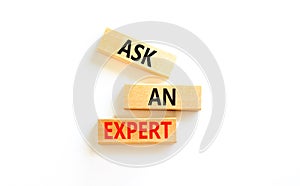 Ask an expert symbol. Concept words Ask an expert on wooden blocks on a beautiful white table white background. Business and ask