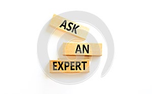 Ask an expert symbol. Concept words Ask an expert on wooden blocks on a beautiful white table white background. Business and ask