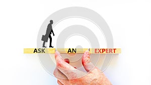 Ask an expert symbol. Concept words Ask an expert on wooden blocks on a beautiful white table white background. Businessman hand.