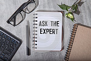 Ask an expert ! text on the page near a cup of coffee
