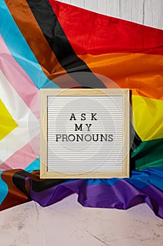 ASK MY PRONOUNS text Neo pronouns concept on Rainbow flag background gender pronouns. Non-binary people rights