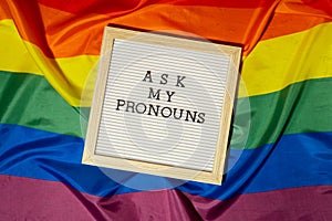 ASK MY PRONOUNS text Neo pronouns concept on Rainbow flag background gender pronouns. Non-binary people rights