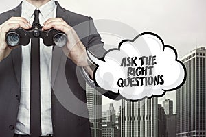 Ask the right questions text on blackboard with businessman