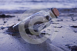 Asking for assistance, optimism and survivor desperation to contact the world conceptual idea with a message in a glass bottle