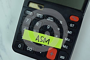 ASM and Calculator write on sticky notes isolated on Wooden Table