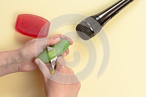 ASMR concept. Specific auditory irritants. Woman hands cut soap in front of the microphone. Top view, flat lay photo