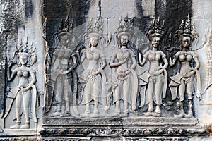 Aspara dancers, dancing girls on bas-relief, scarved in stones of Angkor Wat, Siem Reap, Cambodia, Asia. Scarving