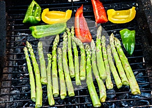 Asparagus and bell peppers on a barbecue bbq charcoal grill.