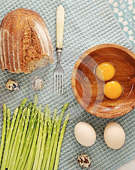 Asparagus, bread and quail eggs and chicken eggs broken