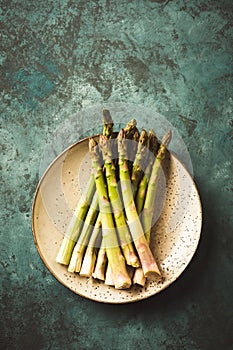 Asparagus close-up on a plate and green background