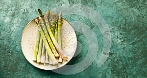 Asparagus close-up on a plate and green background