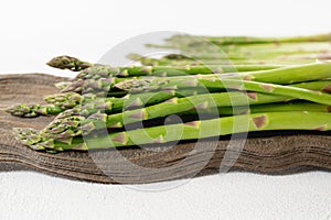 Asparagus Close up on Wooden Board on White Background